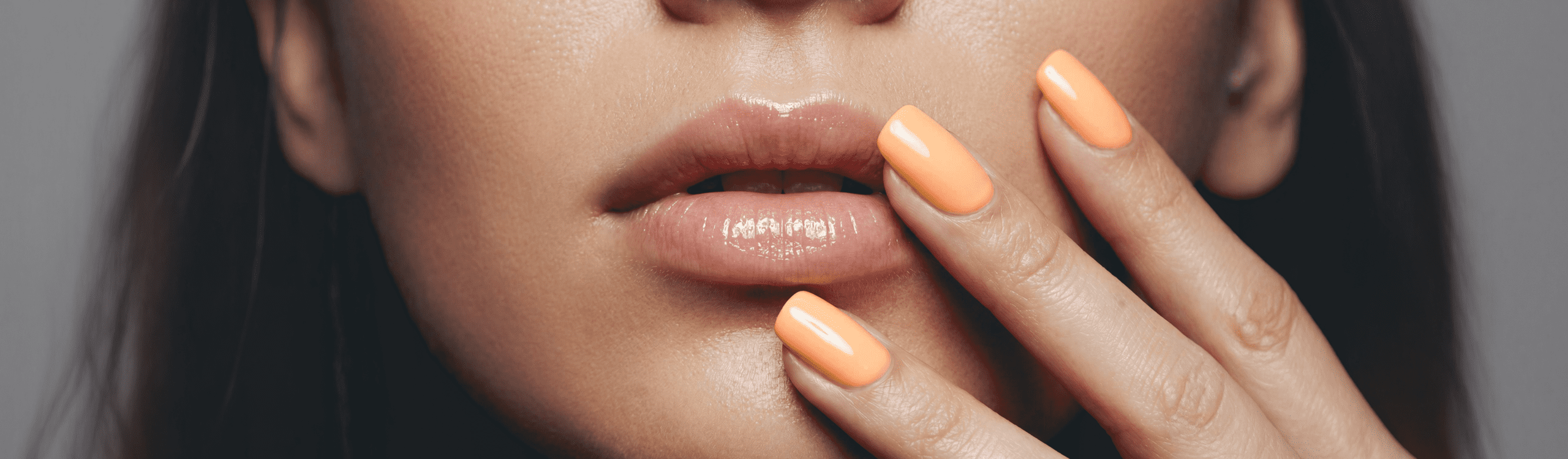 Woman with orange Glamazone gel polish on nails